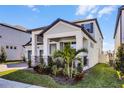 Two-story house with light gray siding, two-car garage, and palm trees at 12164 Eastmoor Dr, Winter Garden, FL 34787