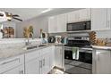 Updated kitchen featuring stainless steel appliances and granite countertops at 126 Scottsdale Sq # 126, Winter Park, FL 32792