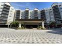Building exterior with a grand entrance and landscaping at 14501 Grove Resort Ave # 2716, Winter Garden, FL 34787