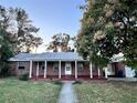 Front view of charming brick house with porch at 2205 12Th Nw St, Winter Haven, FL 33881