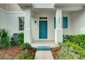 Townhome entrance with teal door and white columns at 2844 Grasmere View Pkwy, Kissimmee, FL 34746