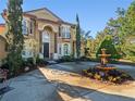 Elegant home with a fountain and well-maintained landscaping at 502 W Lester Rd, Apopka, FL 32712