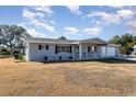 Gray house with covered porch and attached garage at 6524 Sw 108Th Pl, Ocala, FL 34476