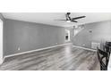 Bright living room featuring hardwood floors and a ceiling fan at 15321 Beamleigh Rd, Winter Garden, FL 34787