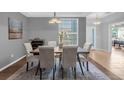 Elegant dining room featuring a wood table and six upholstered chairs at 1813 Sugar Cove Ct, Ocoee, FL 34761