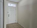 Front entry with white door and tiled floor at 1884 Hickory Bluff Rd, Kissimmee, FL 34744