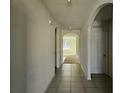 Interior hallway with tiled floor and archways at 1884 Hickory Bluff Rd, Kissimmee, FL 34744