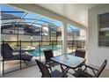Covered patio with pool access, lounge chairs, and a table at 4738 Sleepy Hollow Dr, Kissimmee, FL 34746