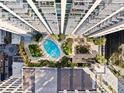 Overhead view of a building's courtyard with a pool and landscaping at 155 S Court Ave # 1316, Orlando, FL 32801