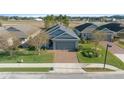 One-story house with gray siding and a brick paver driveway at 3899 Nw 46Th Ter, Ocala, FL 34482