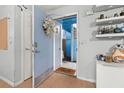 Condo entry with wreath and decorative shelves at 2743 N Poinciana Blvd # 59, Kissimmee, FL 34746