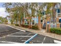 Condo building with parking and tree-lined street at 2743 N Poinciana Blvd # 59, Kissimmee, FL 34746
