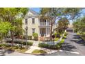 Two-story house with white picket fence, landscaping, and balcony at 4685 Anson Ln, Orlando, FL 32814