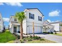 Two-story house with gray shutters, white siding, and a paved driveway at 7212 Oakmoss Loop, Davenport, FL 33837