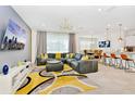 Open concept living space with gray sectional sofa and modern decor at 7212 Oakmoss Loop, Davenport, FL 33837