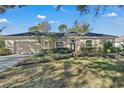 Single-story home with attached two-car garage and well-manicured lawn at 10121 Brandon Cir, Orlando, FL 32836