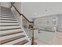 Elegant staircase with dark wood steps and wrought iron railing at 12023 Gold Creek Trl, Windermere, FL 34786