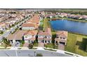 Aerial view showing the home's location in a residential community by a lake at 13333 Oakenshaw Ln, Orlando, FL 32832