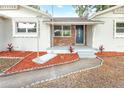 Front porch entry with a unique swing and landscaping at 2827 Euston Rd, Winter Park, FL 32789