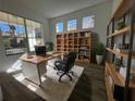 Home office with built-in shelving, large windows, and ample workspace at 5516 Remsen Cay Ln, Windermere, FL 34786