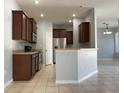 Kitchen features dark wood cabinets and stainless steel appliances at 6612 S Goldenrod Rd # C, Orlando, FL 32822