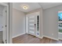 Bright and airy entryway with hardwood floors and modern front door at 7023 Talbot Dr, Orlando, FL 32819