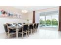 Spacious dining room with large table, chandelier, and view of the pool at 8823 Interlocking Ct, Davenport, FL 33896