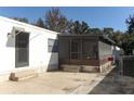 Covered patio with screened enclosure and Beware of Dog sign at 165 Moss Dr, Debary, FL 32713