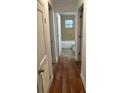 Hallway with wood flooring leading to the bathroom at 1730 N Orange St, Mount Dora, FL 32757