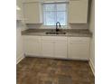 Updated kitchen with white cabinets and granite countertops at 1730 N Orange St, Mount Dora, FL 32757
