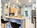 Spacious kitchen with light wood cabinets and granite countertops at 4217 Sky Flower Ln, St Cloud, FL 34772