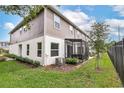 Townhome with screened patio, grassy area, and privacy fence at 4701 New Orleans Cv, Oviedo, FL 32765