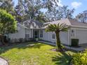 Front view of a single-story house with a landscaped yard at 6018 Spring Creek Ct, Mount Dora, FL 32757