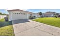 House exterior showing a driveway and well-kept lawn at 610 Crane Dr, Poinciana, FL 34759