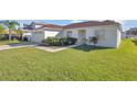House exterior showcasing a neat lawn and driveway at 610 Crane Dr, Poinciana, FL 34759