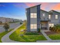 Modern two-story home with stone accents and landscaped yard at 1264 Challenge Dr, Davenport, FL 33896