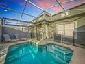 Inviting screened-in pool with lounge chairs and patio furniture at 1264 Challenge Dr, Davenport, FL 33896