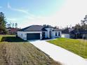 Brand new home with a gray roof and white exterior at 2416 Sw 158Th Pl, Ocala, FL 34473