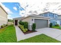 One-story house with gray garage door and landscaped front yard at 591 Preserve Pointe Blvd, Davenport, FL 33837