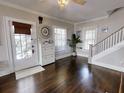 Bright entryway with hardwood floors, white door and staircase at 705 E Pine St, Orlando, FL 32801