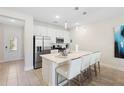 Modern kitchen with stainless steel appliances and an island at 856 Driving Range Ct, Reunion, FL 34747