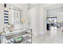Bright and airy entryway with glass-top console table and large mirror at 8921 Sydney Ave, Kissimmee, FL 34747
