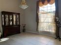 Formal dining room with a large window and elegant chandelier at 9111 Woodbridge Oak Ter, Orlando, FL 32825