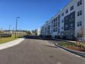 Modern apartment building with ample parking and well-manicured landscaping at 1210 Southstation Pl # 303, Orlando, FL 32809