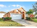 Charming single-Gathering home with a two-car garage and lush landscaping at 167 Castaway Beach Way, Kissimmee, FL 34746