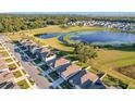 Aerial view of a residential neighborhood near a lake at 3290 Logan Berry Dr, Mount Dora, FL 32757