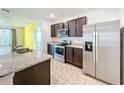Modern kitchen with stainless steel appliances and granite countertops at 3290 Logan Berry Dr, Mount Dora, FL 32757