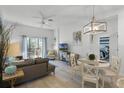 Living room with comfortable seating, dining area, and access to a balcony at 411 Lucaya Loop # 411, Davenport, FL 33897