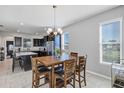 Breakfast nook with wood table and chairs, adjacent to a modern kitchen at 4700 Nathan Hale Blvd, St Cloud, FL 34769