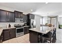 Spacious kitchen with island, dark cabinetry, and stainless steel appliances at 4700 Nathan Hale Blvd, St Cloud, FL 34769